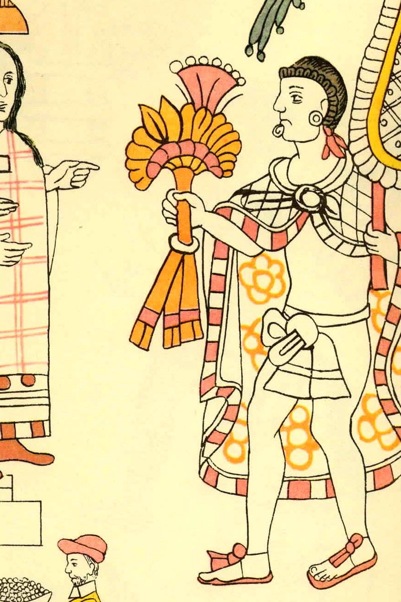 Lienzo de Tlaxcala, plate 11 — the meeting of Cortés, La Malinche and Motecuhzoma (Chavero facsimile, 1892); public domain via Wikimedia Commons An Aztec lord with a feather fan and ornate cloak faces La Malinche translating for the Spaniards — el encuentro. Lienzo de Tlaxcala, plate 11.